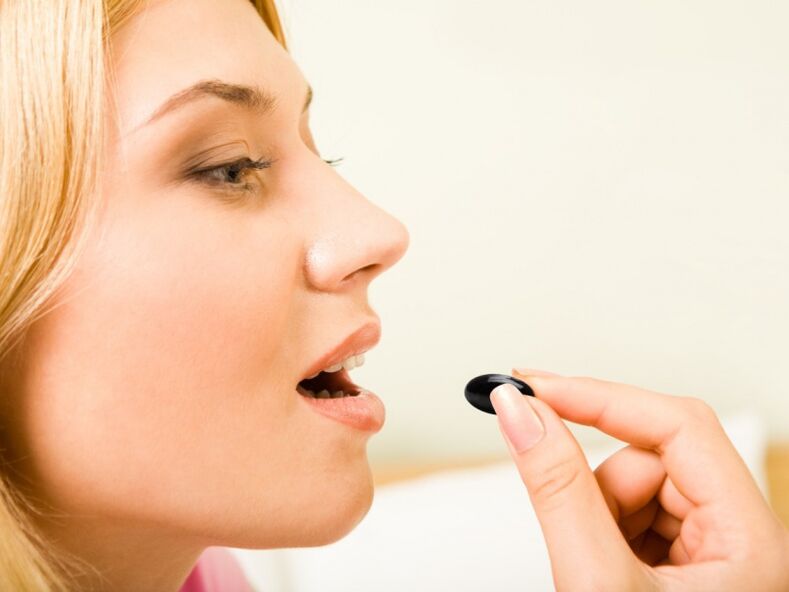 Girl takes medicine to prevent parasites